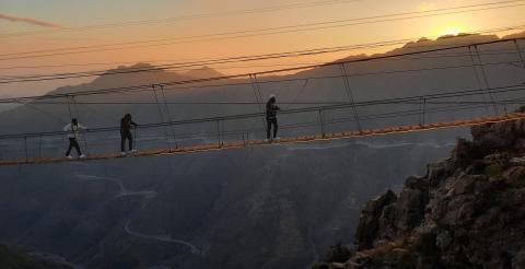 People walking across a rope bridge in Saudi Arabia