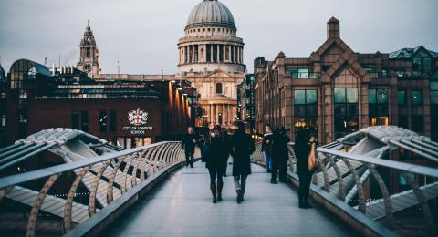 People crossing the Millennium Bridge in London, England