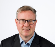 Man wearing a suit and smiling