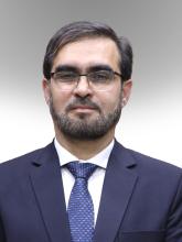 A man with glasses in a suit